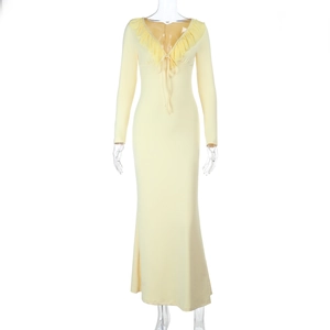 Detail of ruffled neckline and tie design on a slim-fit yellow long-sleeved dress
