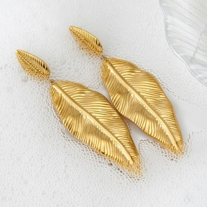 Minimalist gold leaf drop earrings with vein texture on a fresh water drop background