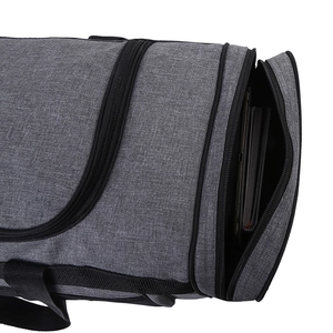 Close-up of grey oxford cloth duffel bag featuring side circular pocket and black zippers