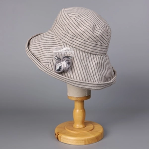 Detail of striped cotton linen sun hat with wide brim and adjustable grey wind lanyard