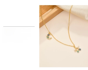 Detail of 925 silver necklace with moon and star pendant featuring blue and white zircons