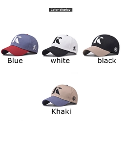 Detail of color-block cotton baseball caps featuring embroidered letter K and eagle wing logos