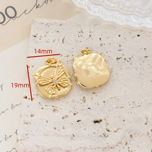 Detailed macro view of gold butterfly pendant with measurements 14mm by 19mm