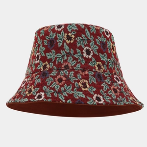 Detail of red floral jacquard fabric on bucket hat showing intricate flower embroidery