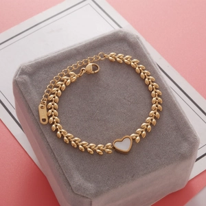 Close-up of golden stainless steel heart bracelet with lobster clasp and K18 tag