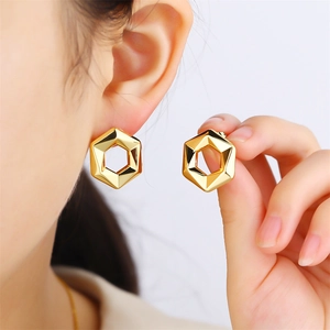 Vintage style geometric hollow hexagon stud earrings in polished golden metal for women