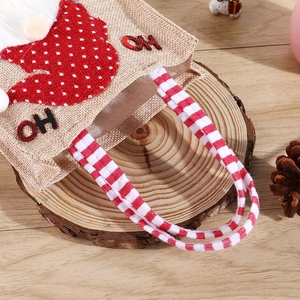 Gnome burlap Christmas gift bag with red plaid handles and HO HO embroidery detail