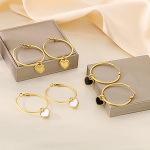 Gold twisted hoop earrings with heart-shaped pendants in white, black and gold finish