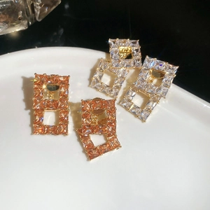 Macro shot of rectangular hollow pendants with champagne and clear zircon crystals