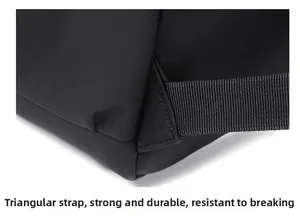 Close-up of reinforced triangular stitching on black backpack straps for durability