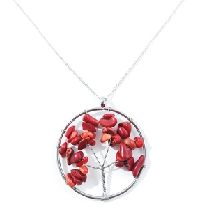 Detailed shot of handmade silver wire tree of life pendant with red natural crystal stones