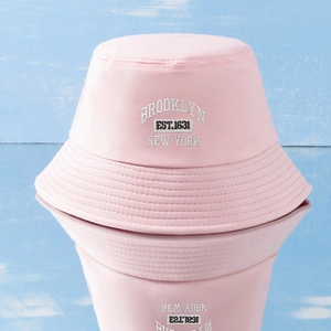 Detailed embroidery of Brooklyn New York logo on a pink cotton canvas bucket hat