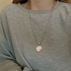 Titanium steel Venus face relief pendant necklace in silver finish worn by model