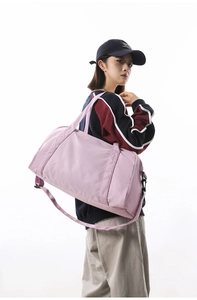Large capacity pink gym duffel bag carried by model for travel and active sports
