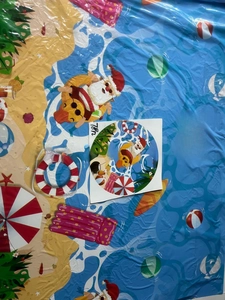 Detail of 78-inch Christmas beach themed tablecloth featuring colorful summer motifs