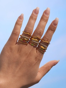 Detail of 18K gold-plated rings with colorful stones and pavé zircons on hand