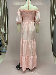 Back view of light pink off-shoulder tiered maxi dress with smocked bodice and puff sleeves
