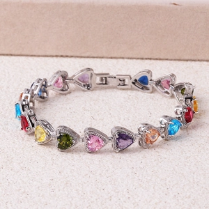 Detail view of silver bracelet with colorful heart-shaped zircon stones in a row