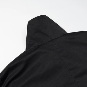 Detail of the high collar and neat stitching on this black long coat's back neckline