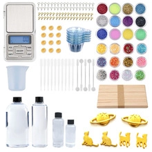 Macro view of complete resin DIY kit with epoxy glue, glitter, and tools for jewelry making