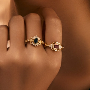 Vintage gold rings with oval sapphire and rectangular ruby stones in carved settings