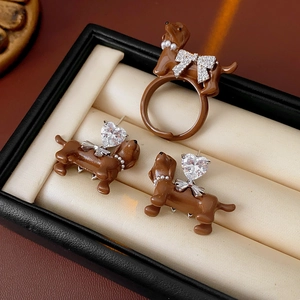 Macro view of brown dachshund dog jewelry set with pearls and crystals in a box
