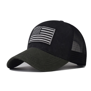 Detail of classic black trucker hat with American flag embroidery and breathable mesh