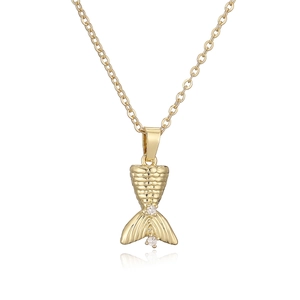 Elegant gold fish tail pendant necklace with sparkling crystals on white background
