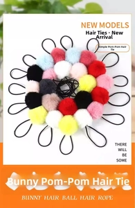 Detail of colorful plush pom pom hair ties set featuring high elastic black rubber bands