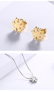 Detail showing golden snowflake stud earrings and silver snowflake necklace set