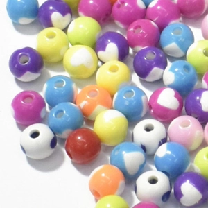 Close-up of colorful acrylic heart beads for kids' DIY jewelry making and threading crafts