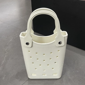 Close-up of white waterproof EVA beach bag with circular holes and metal rivets