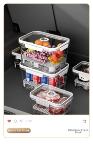 Stackable fruit bento boxes with drain trays organized in a car trunk for camping