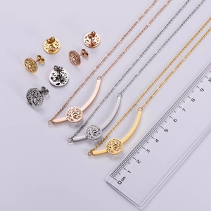 Detailed view of Tree of Life jewelry set in four colors next to a measuring ruler
