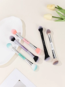 Detail of dual-ended makeup brushes in multiple colors with synthetic bristles and metal ferrules