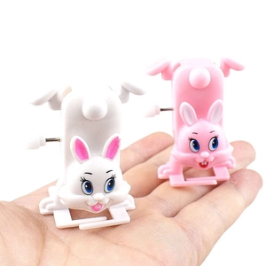 Wind-up walking bunny toys in pink and white plastic with a side mechanical knob