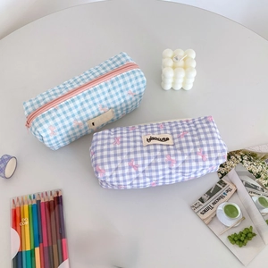Flatlay of cream plaid bow pencil cases in blue and purple styles for students