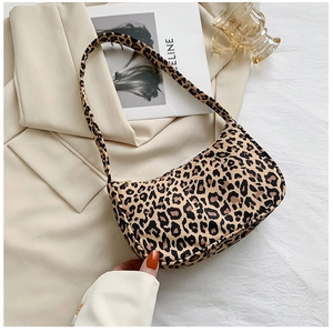 Close-up of leopard print shoulder bag with crescent shape and smooth zipper detail