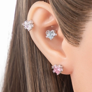 Star heart zircon stud earrings set in silver titanium steel on a model ear