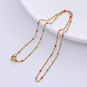Close-up of golden O-chain necklace featuring multi-colored enamel beads details