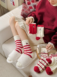 Detailed view of red and white striped warm socks with cute animal embroidery and plush trim