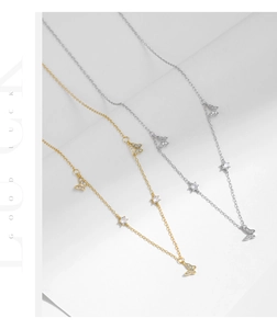 Close-up of s925 silver butterfly necklaces with sparkling pavé stones in gold and silver
