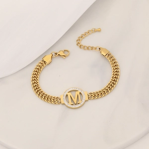 Golden double-row chain bracelet with a sparkling crystal-encrusted letter M pendant