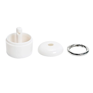 Detail view of portable jewelry storage container components with ring and white lid