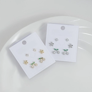 Macro shot of S925 silver stud earring set with cherry and flower zircon designs