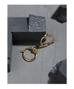 Detailed macro shot of S925 hallmark on gold knotted sterling silver earrings