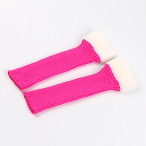 Detail of pink knitted leg warmers featuring soft white faux fur trim and cozy texture