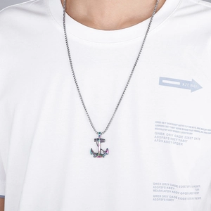 Rainbow anchor pendant necklace for men with silver box chain worn by a male model