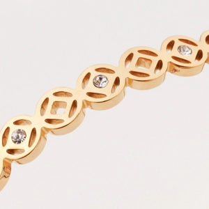 Gold stainless steel coin pattern bracelet with cubic zirconia hollow design