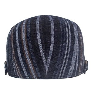 Detail view of striped winter beret featuring corduroy texture and metal side buckle